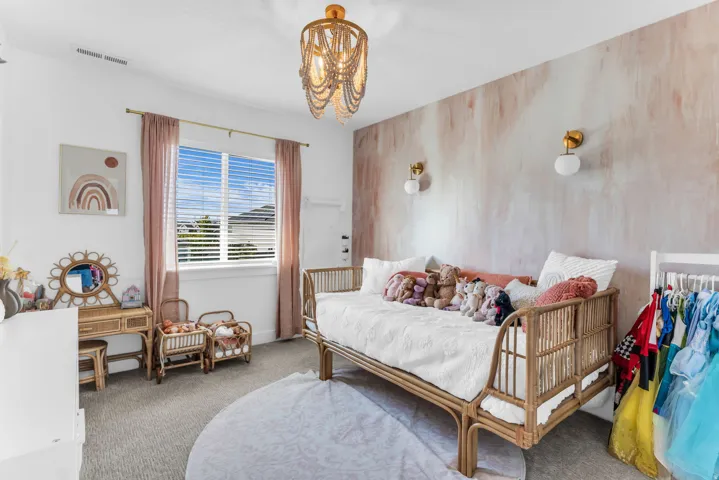 Recessed lighting, window with blinds, decorative wall treatment, two wall-mounted sconces, and a ceiling-mounted light fixture