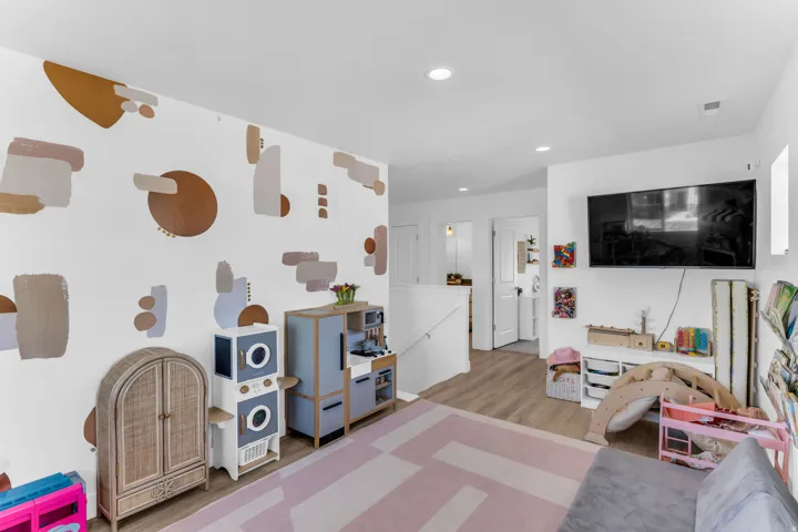 Recessed lighting illuminating wood-finish flooring