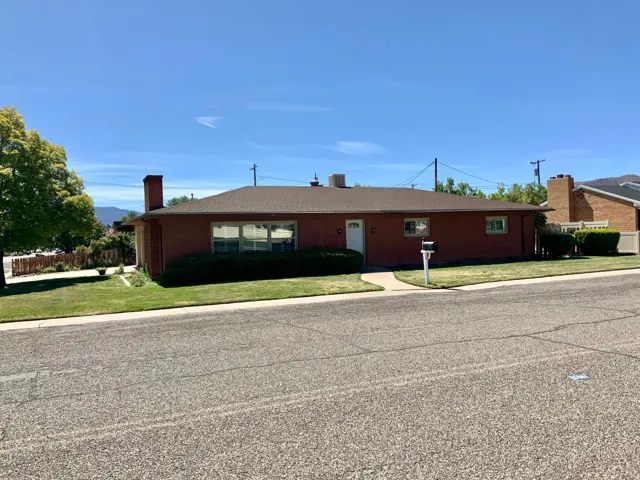 Brick exterior with a brown roof and a front walkway