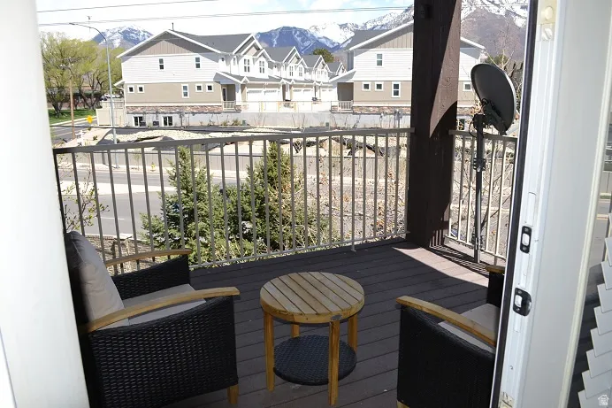 Balcony featuring composite decking and a metal railing