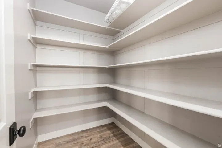 Built-in shelving, wood-finish flooring, and a black door knob