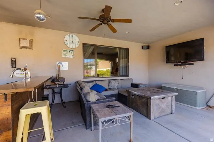 Covered patio featuring a built-in outdoor bar with a sink, recessed lighting, and a ceiling fan