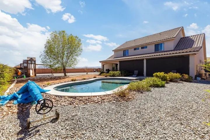 In-ground pool featuring a stone coping surround