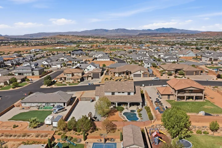 Expansive property featuring a private swimming pool, mature landscaping, and a spacious paved driveway