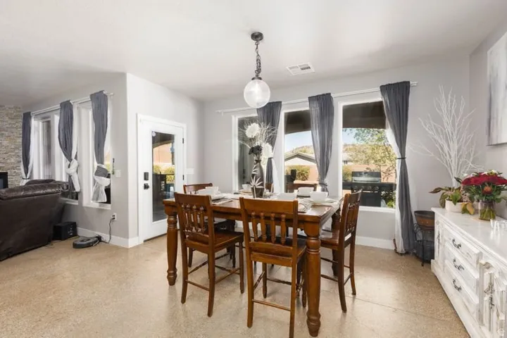 Recessed lighting, light-toned flooring, pendant light fixture, French door, multiple windows