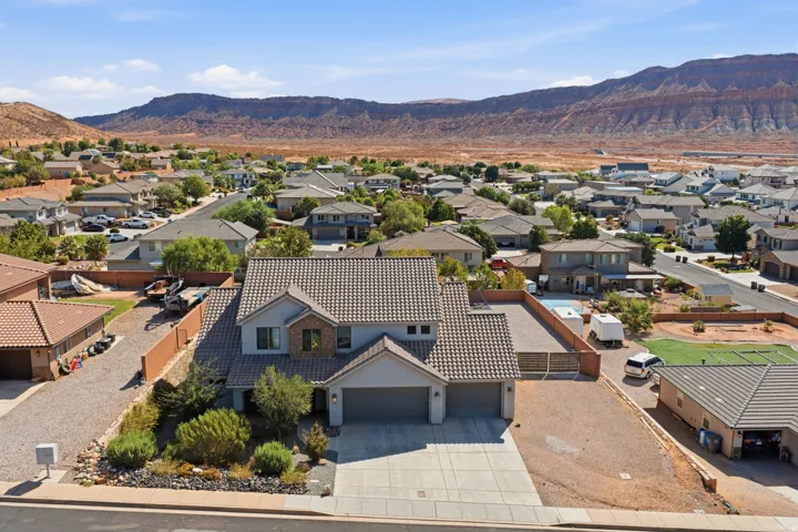 Stucco and stone facade home with a tile roof, an attached two-car garage, and a concrete driveway