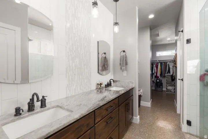 Double vanity with integrated sinks and dark wood cabinetry