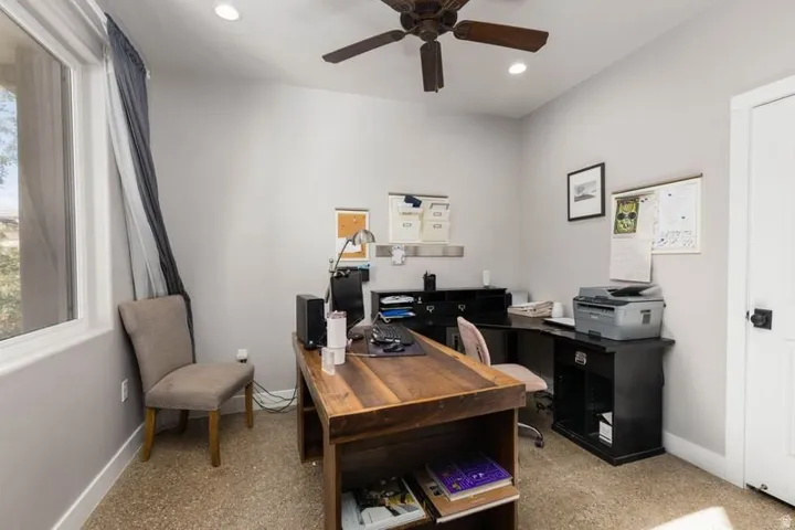 Recessed lighting, ceiling fan, and window with natural light