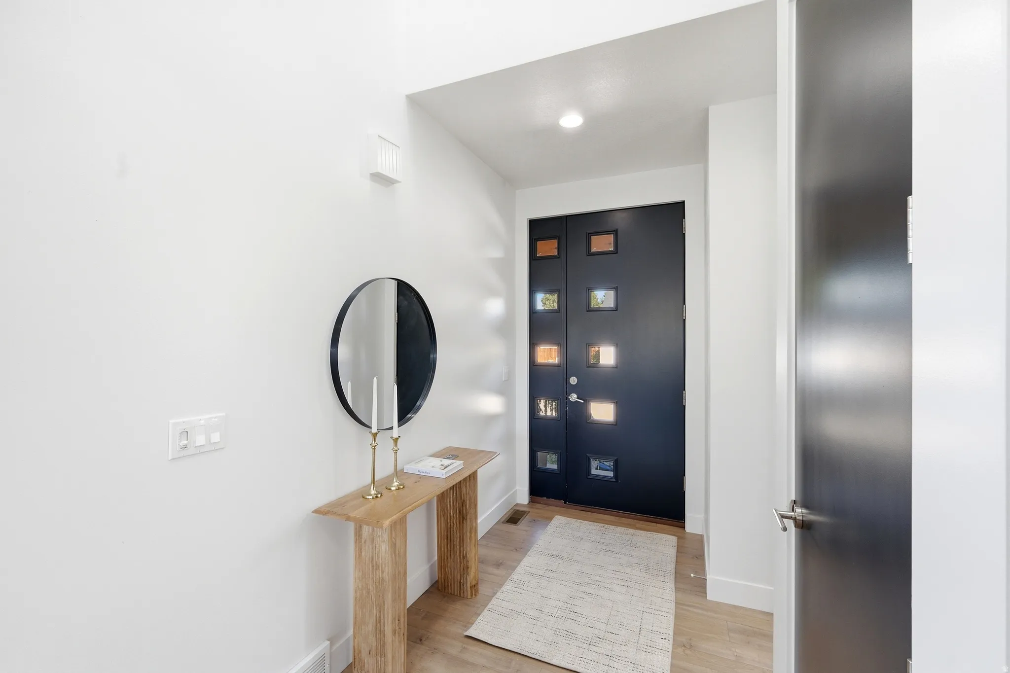 Entry with modern peek-a-book door
