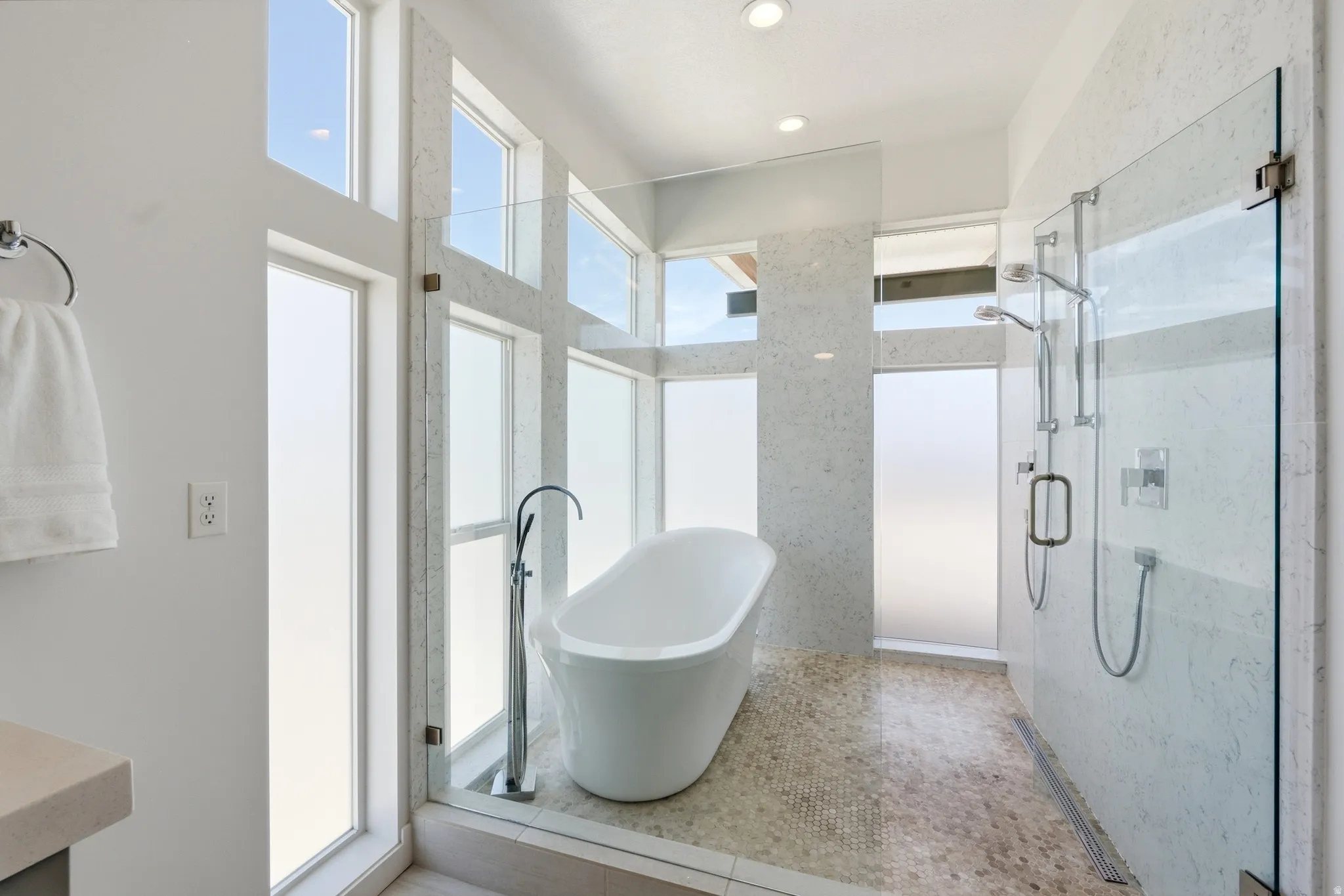 Primary bathroom wet room with soaking tub and dual shower heads