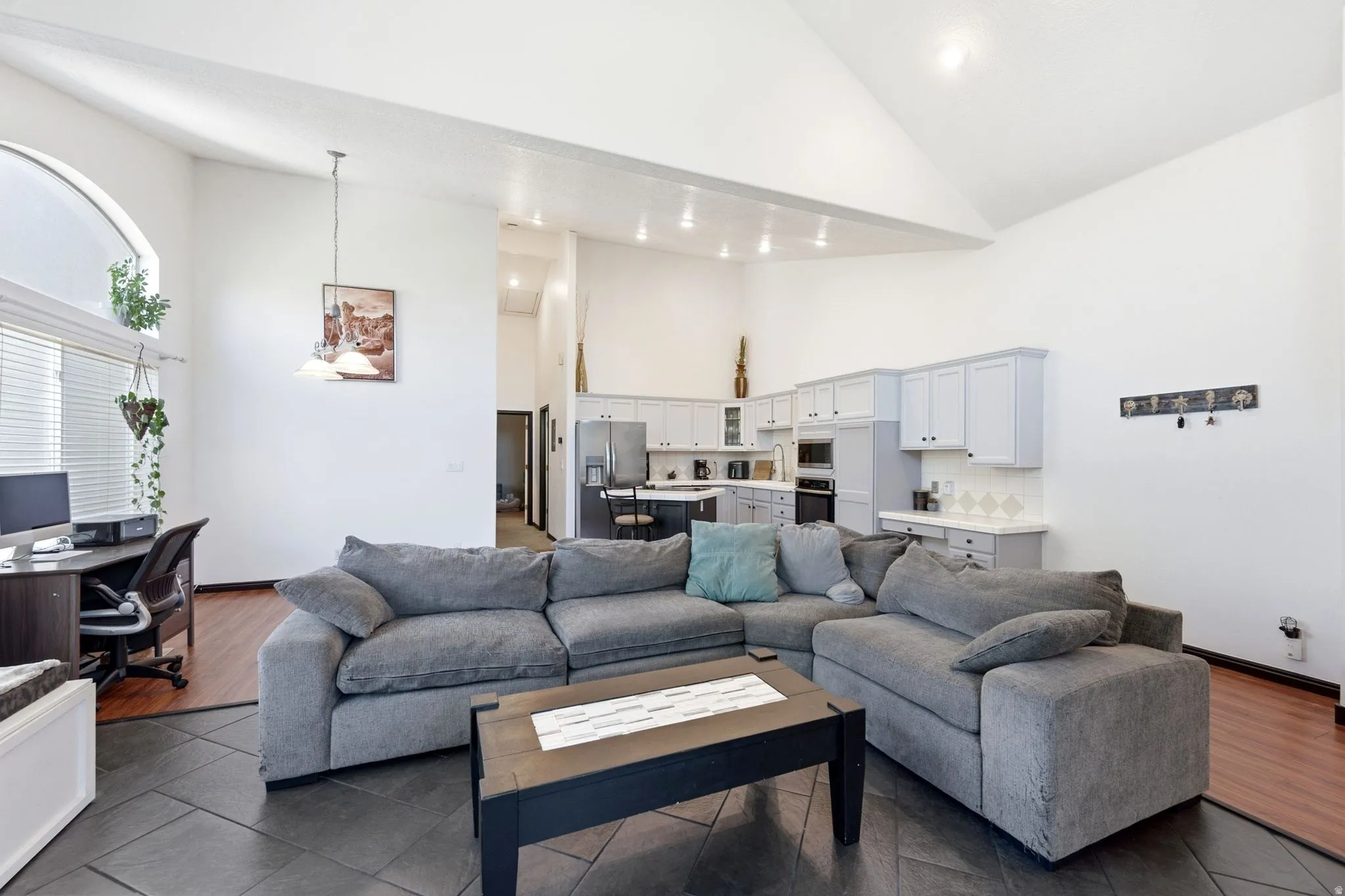 Vaulted ceilings and recessed lighting illuminate the open-concept design
