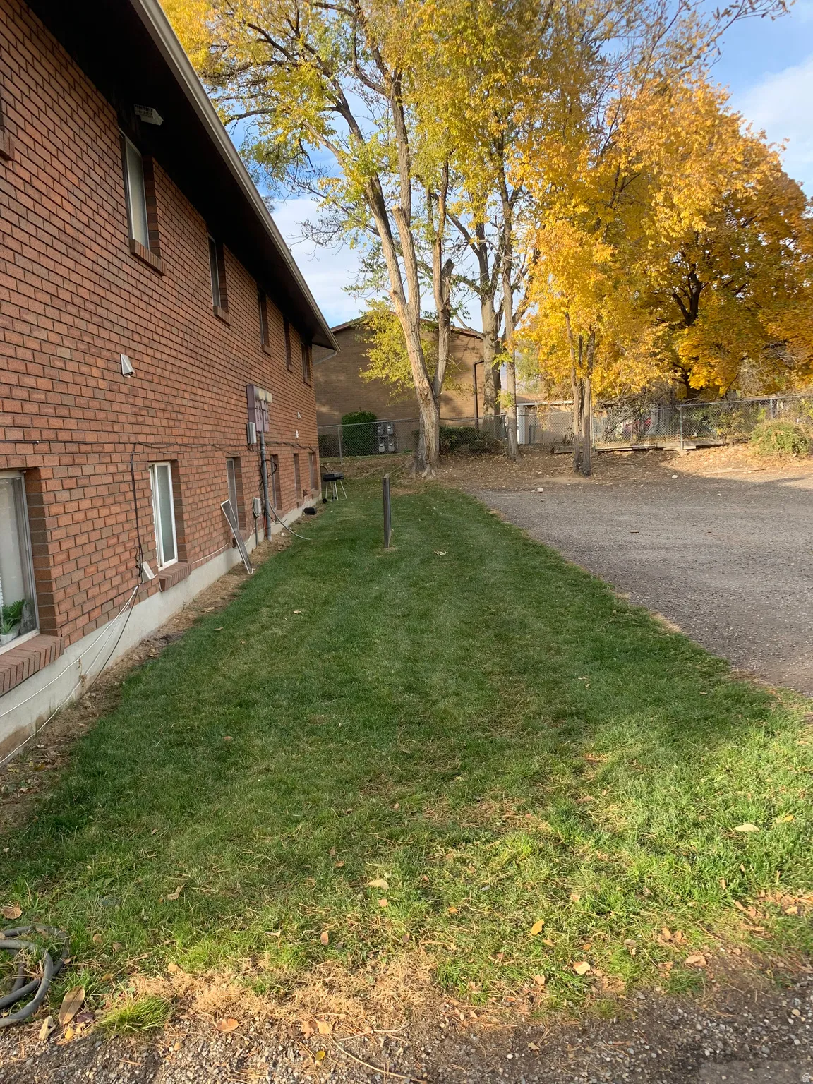 Brick exterior, manicured lawn, paved surface