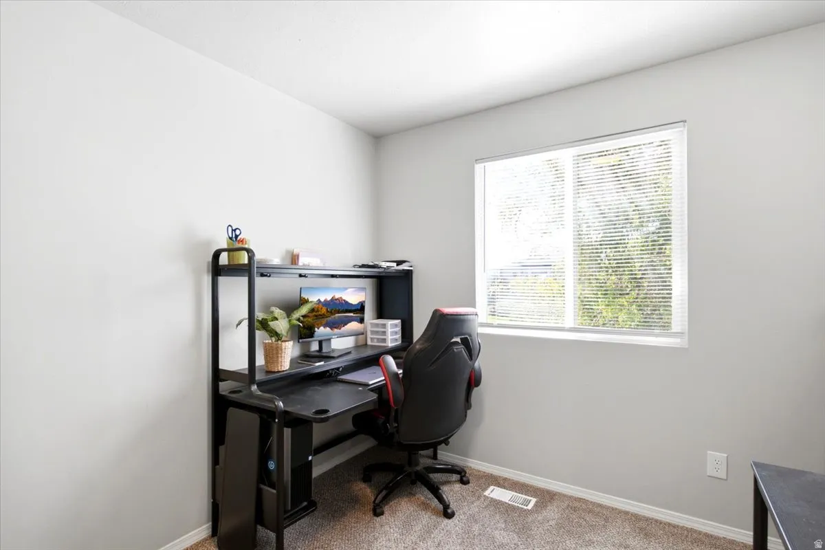 Recessed lighting, neutral wall paint, window with blinds, and carpet flooring
