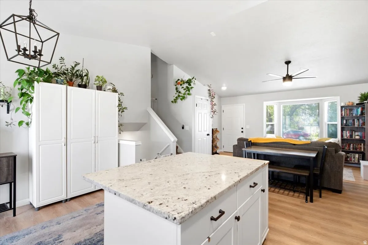 Kitchen island with a light-colored countertop and white cabinetry