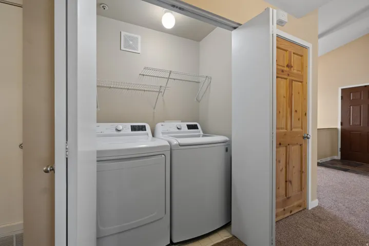 Dedicated laundry area with built-in wire shelving