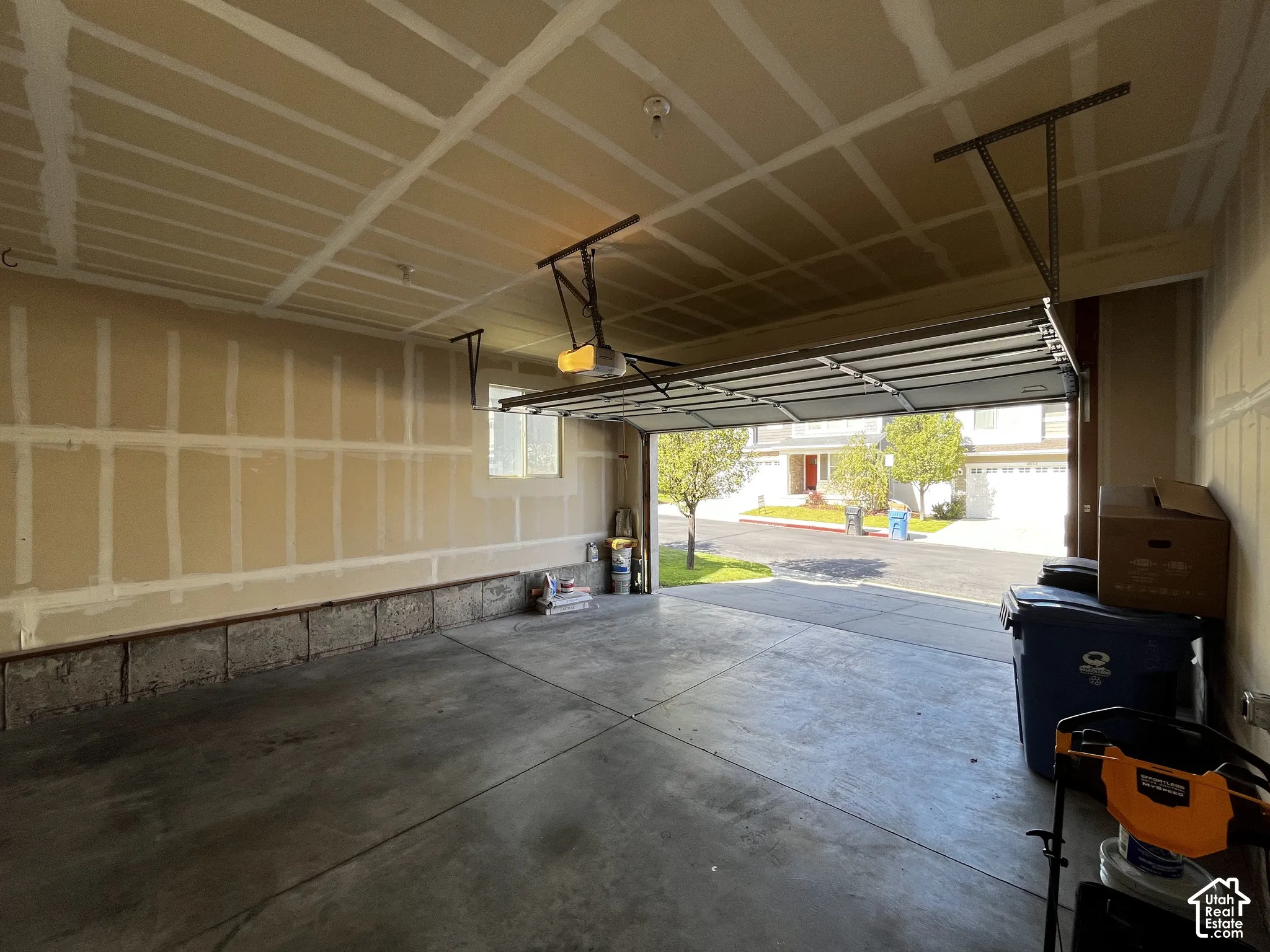 Concrete flooring, window, and an automatic garage door opener