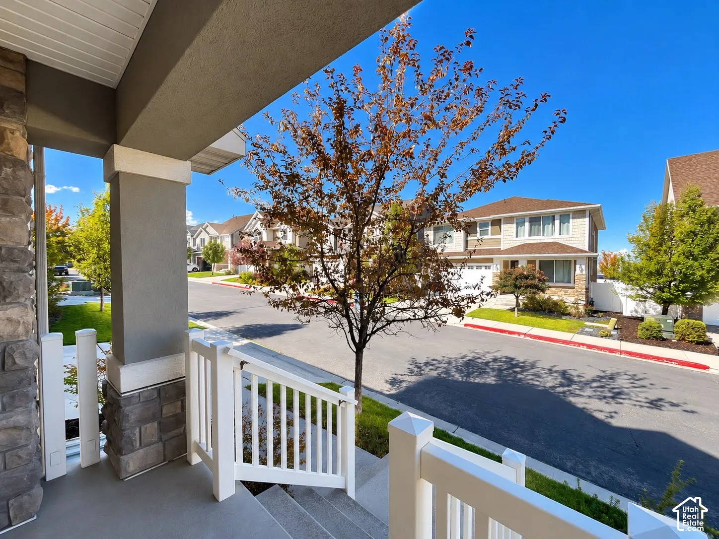 Covered entryway with stone veneer and stucco columns