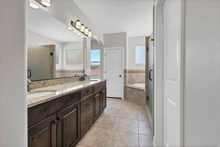 Dual vanity with a stone countertop and integrated sinks
