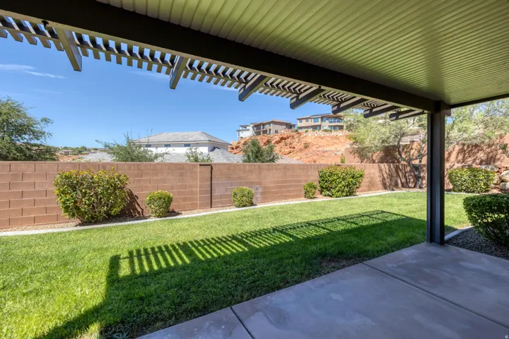Expansive concrete patio with a covered pergola