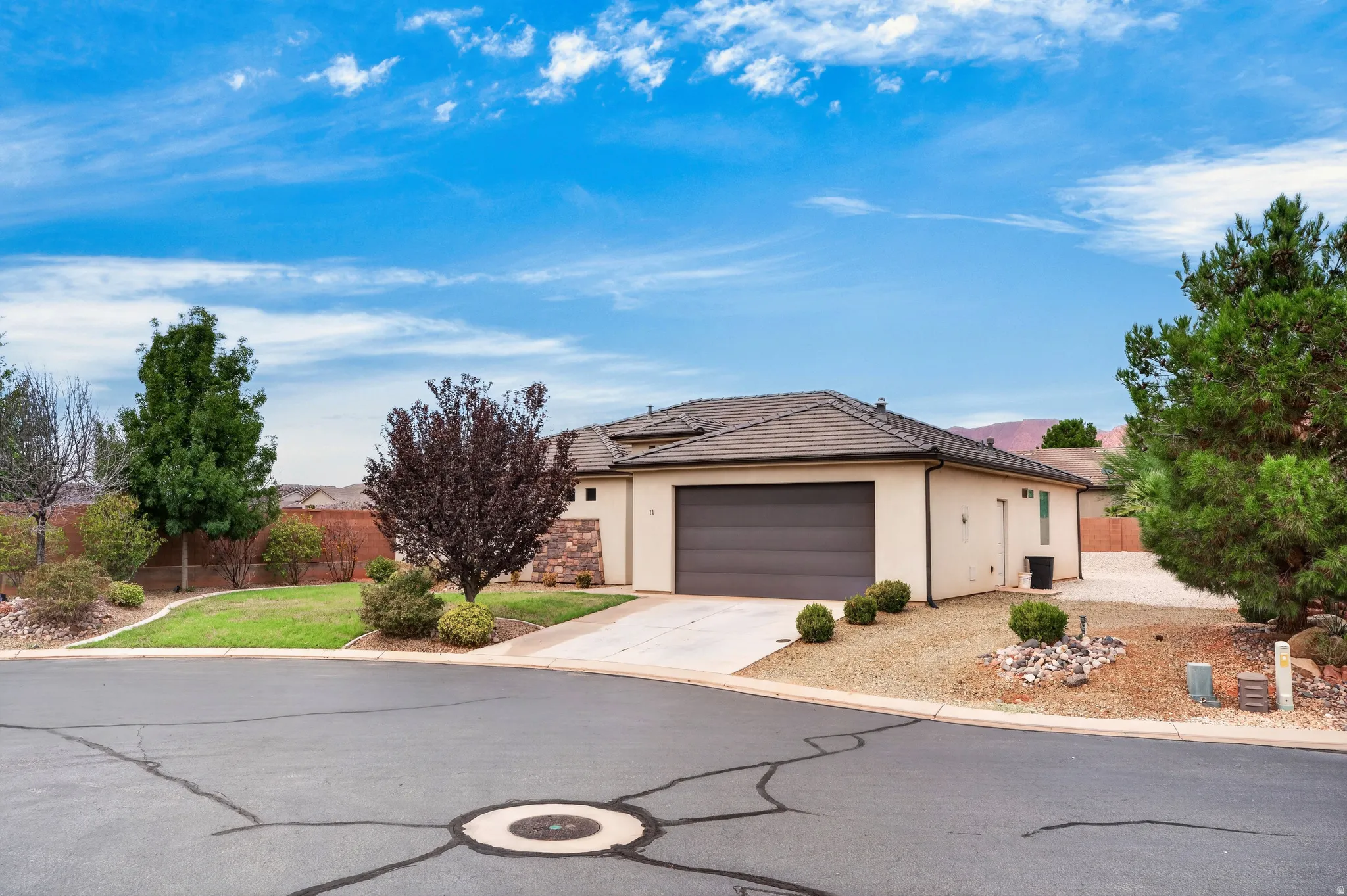Contemporary stucco exterior with a tiled roof