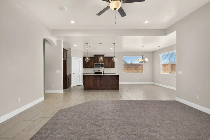 Kitchen with dark wood cabinetry, stainless steel appliances, and a central island