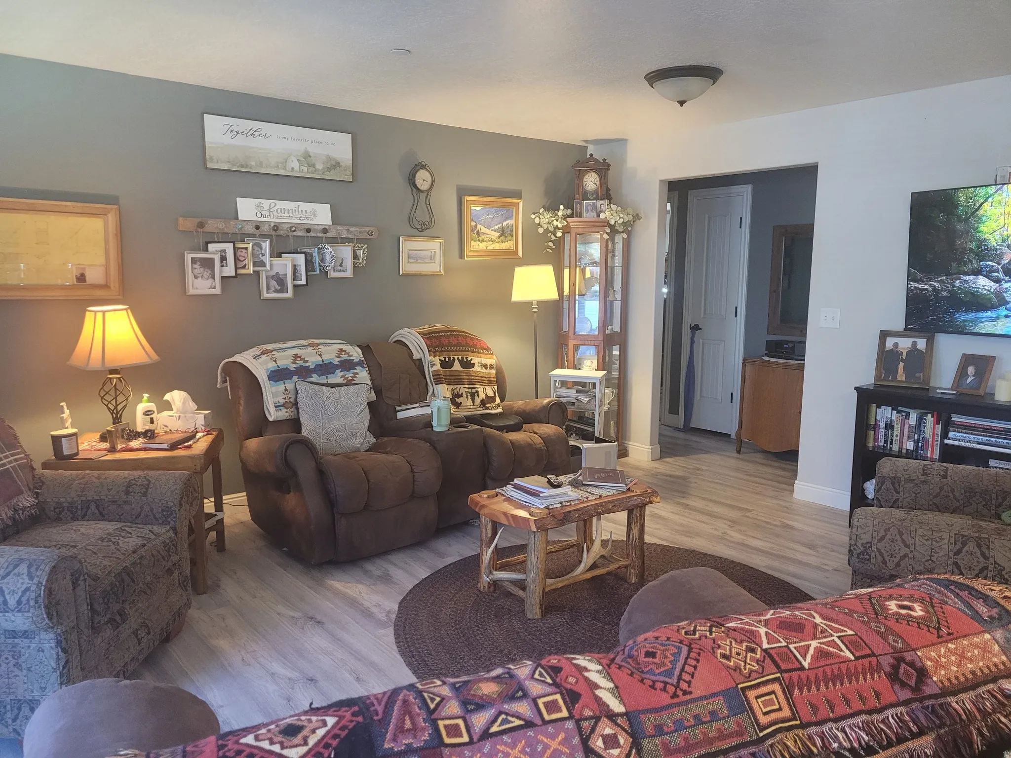 Light wood-finish flooring, recessed lighting, and a neutral wall color