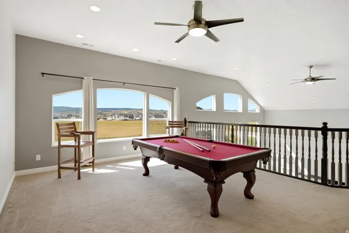 Vaulted ceiling with recessed lighting and ceiling fans