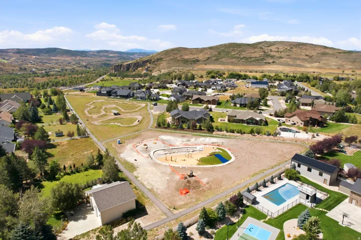Expansive neighborhood featuring residential properties, recreational areas, and natural landscaping