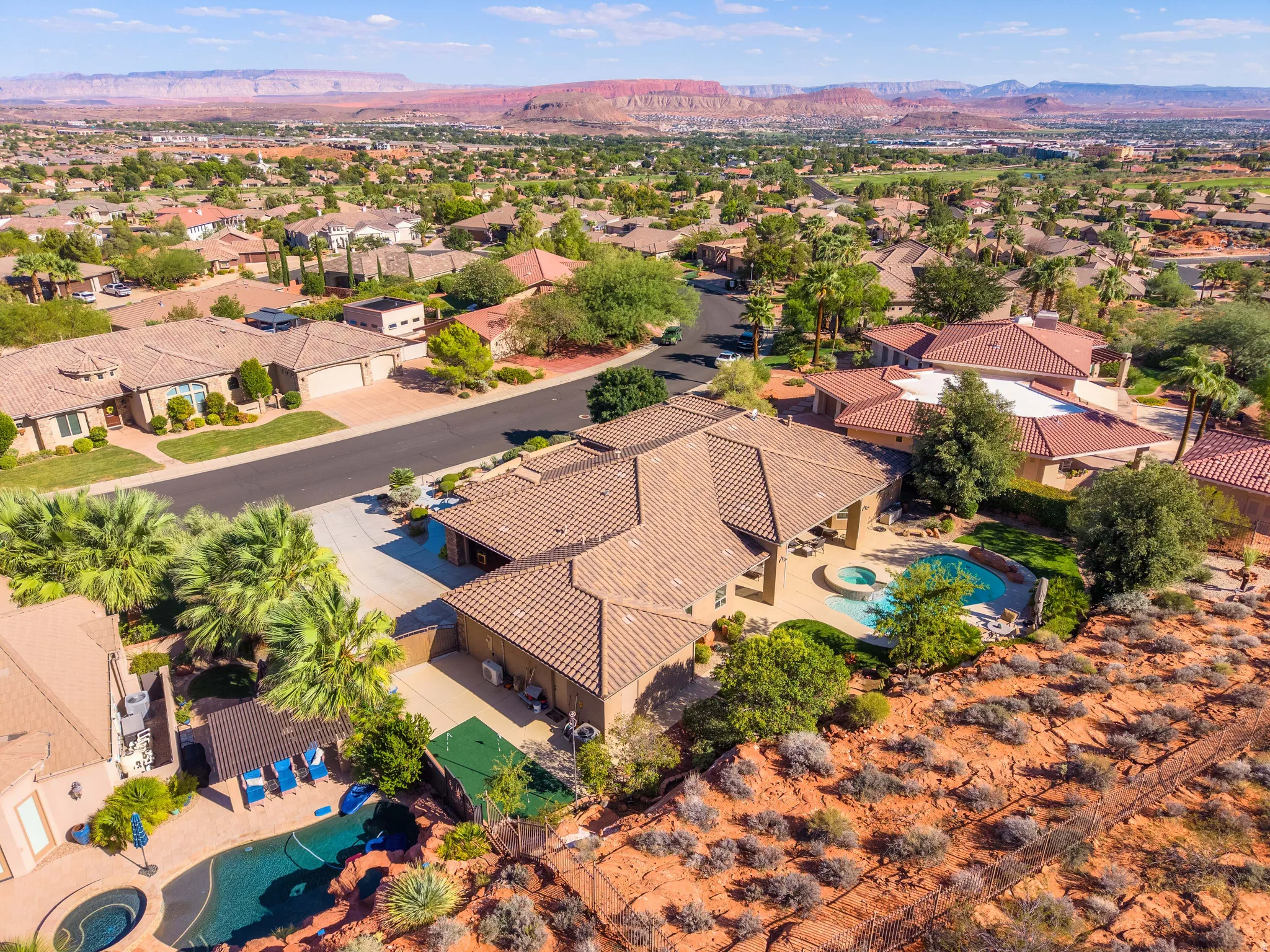 Expansive property featuring a swimming pool, integrated spa, and mature landscaping