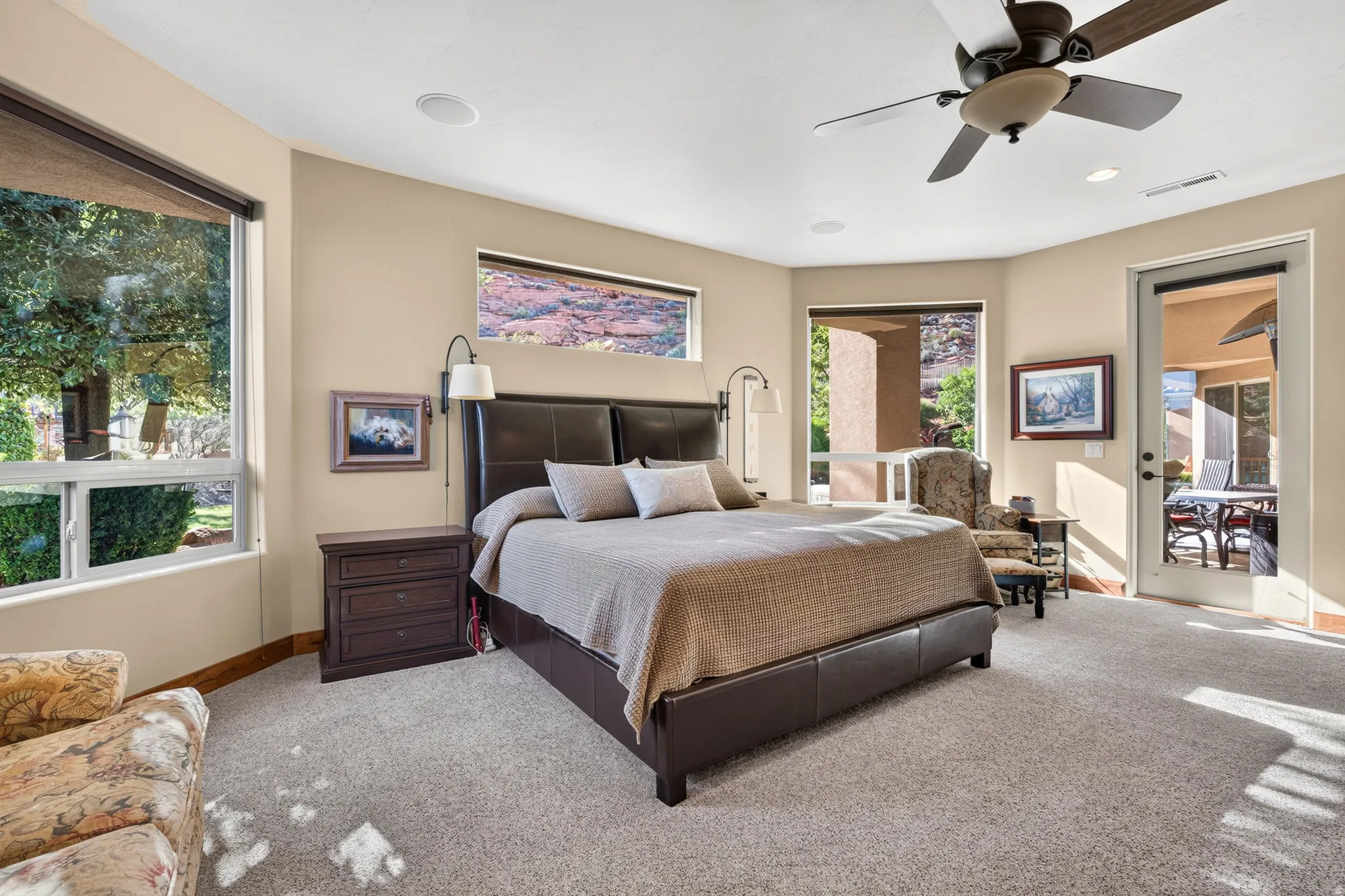 Carpeted room with multiple windows providing natural light