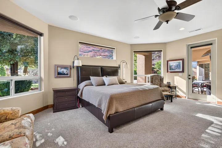 Carpeted room with multiple windows providing natural light