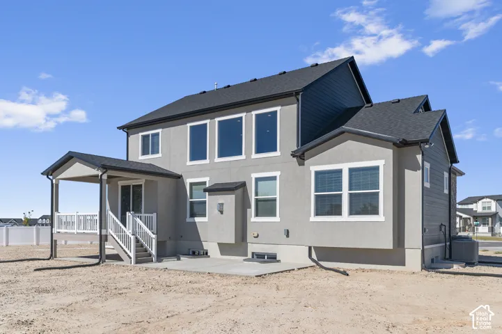 Two-story exterior featuring a stucco and horizontal siding fa