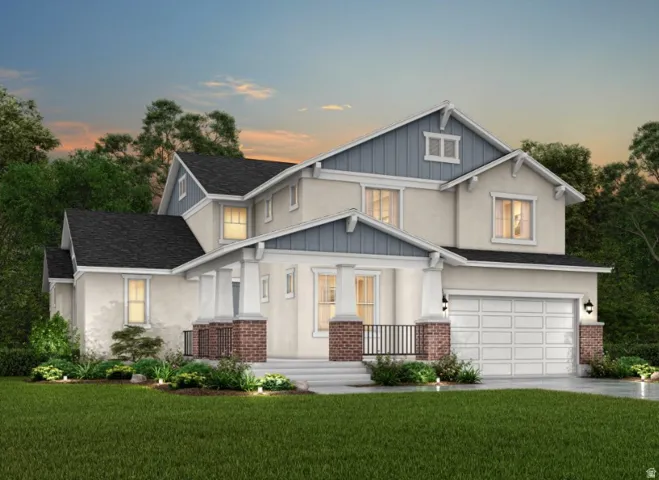 Two-story residence featuring a garage, a covered front entry with columns and brick accents, and a landscaped front yard with a manicured lawn