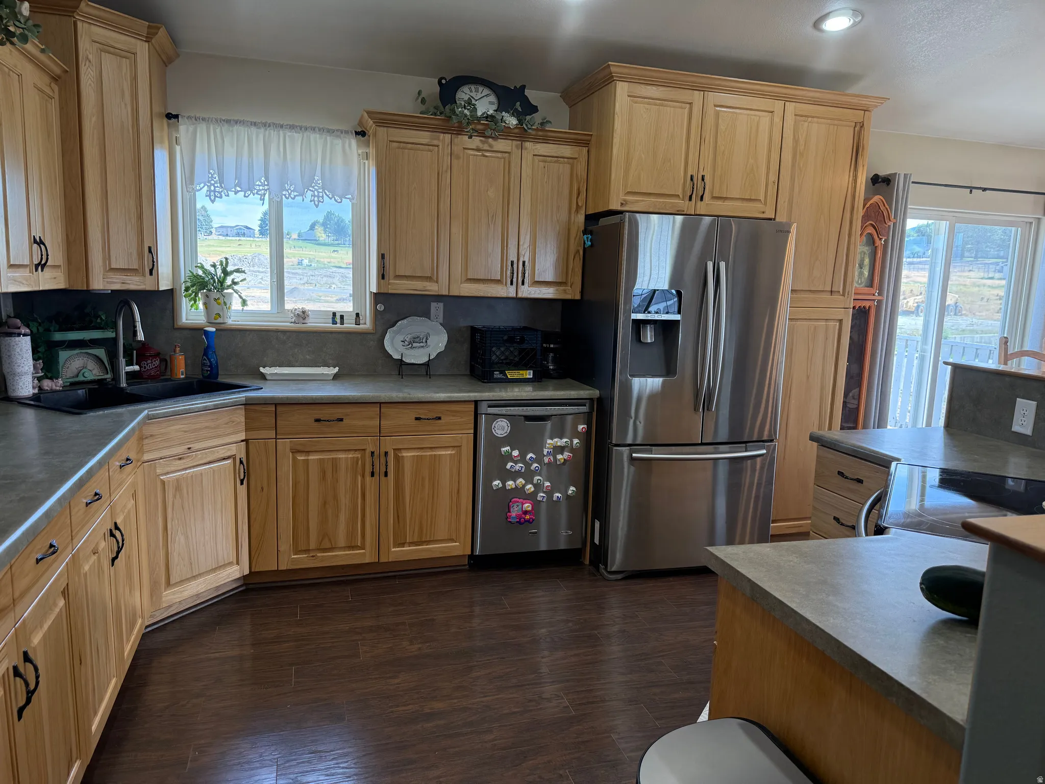 Wood-finish flooring complemented by light wood cabinetry with dark hardware
