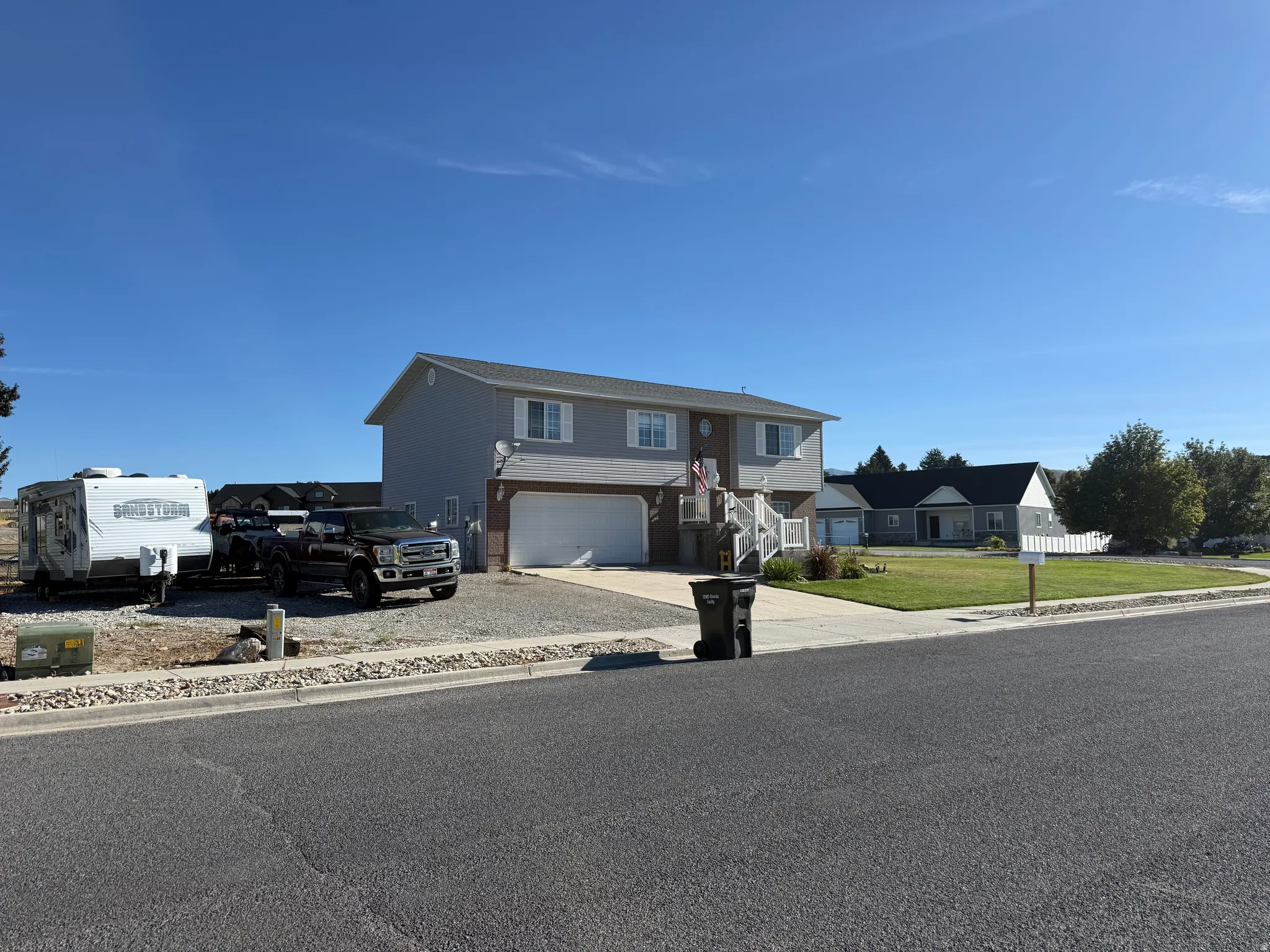 Two-story residence with light gray siding and white trim