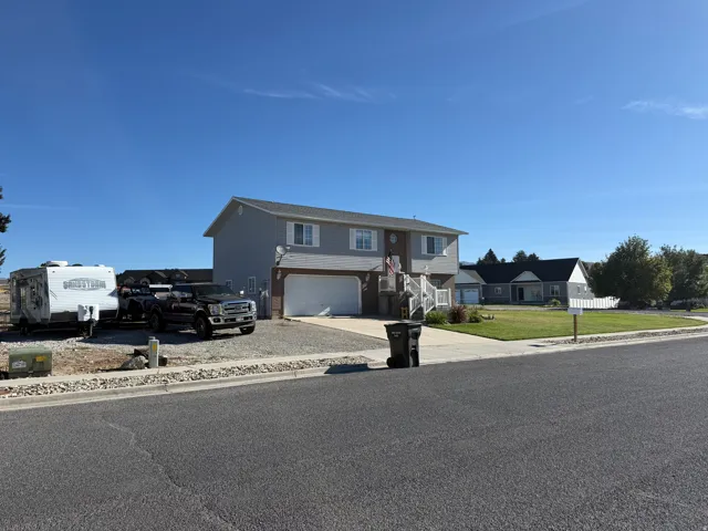 Two-story residence with light gray siding and white trim