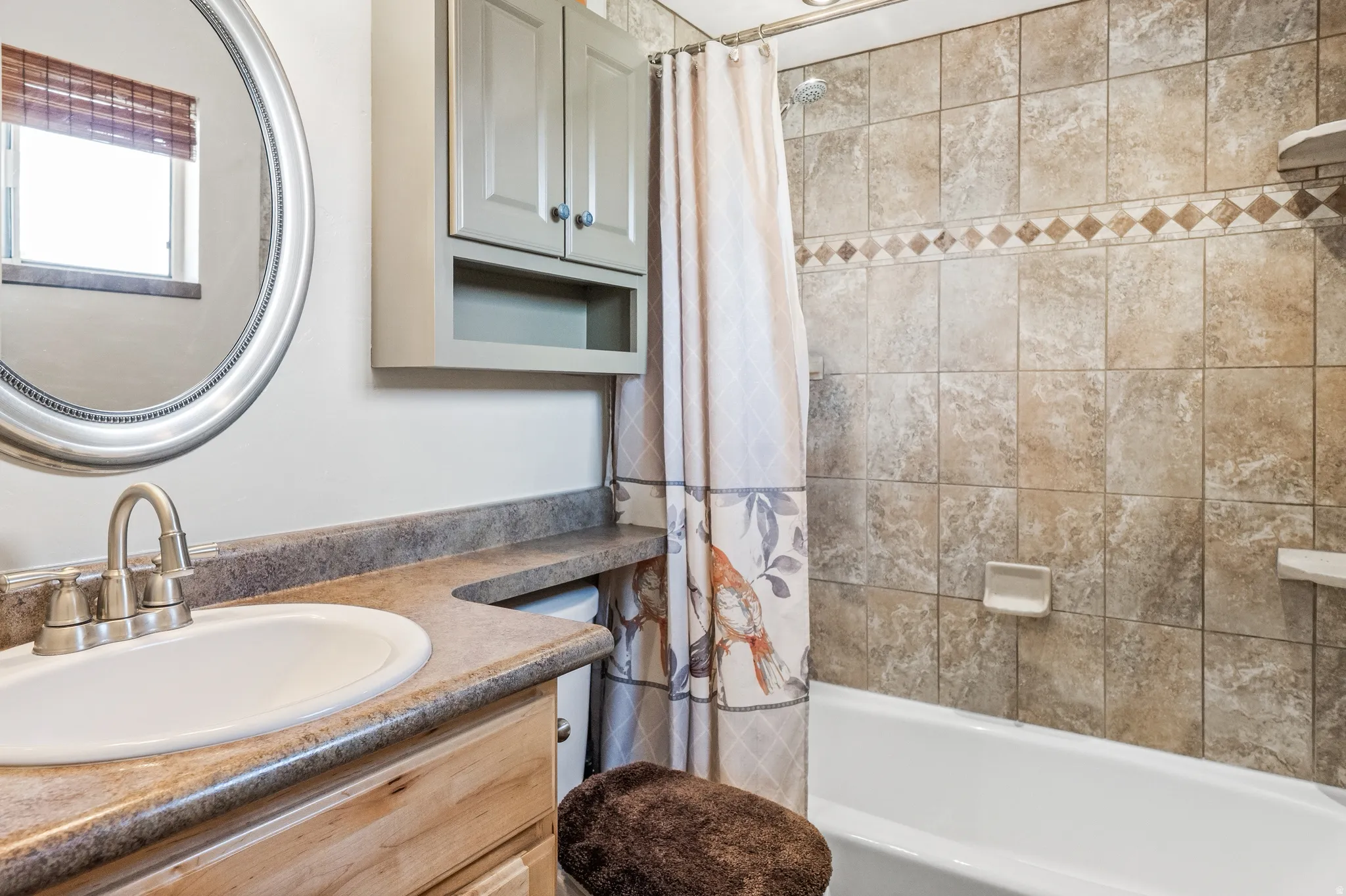 Primary full bath with custom tile surround and quartz countertops
