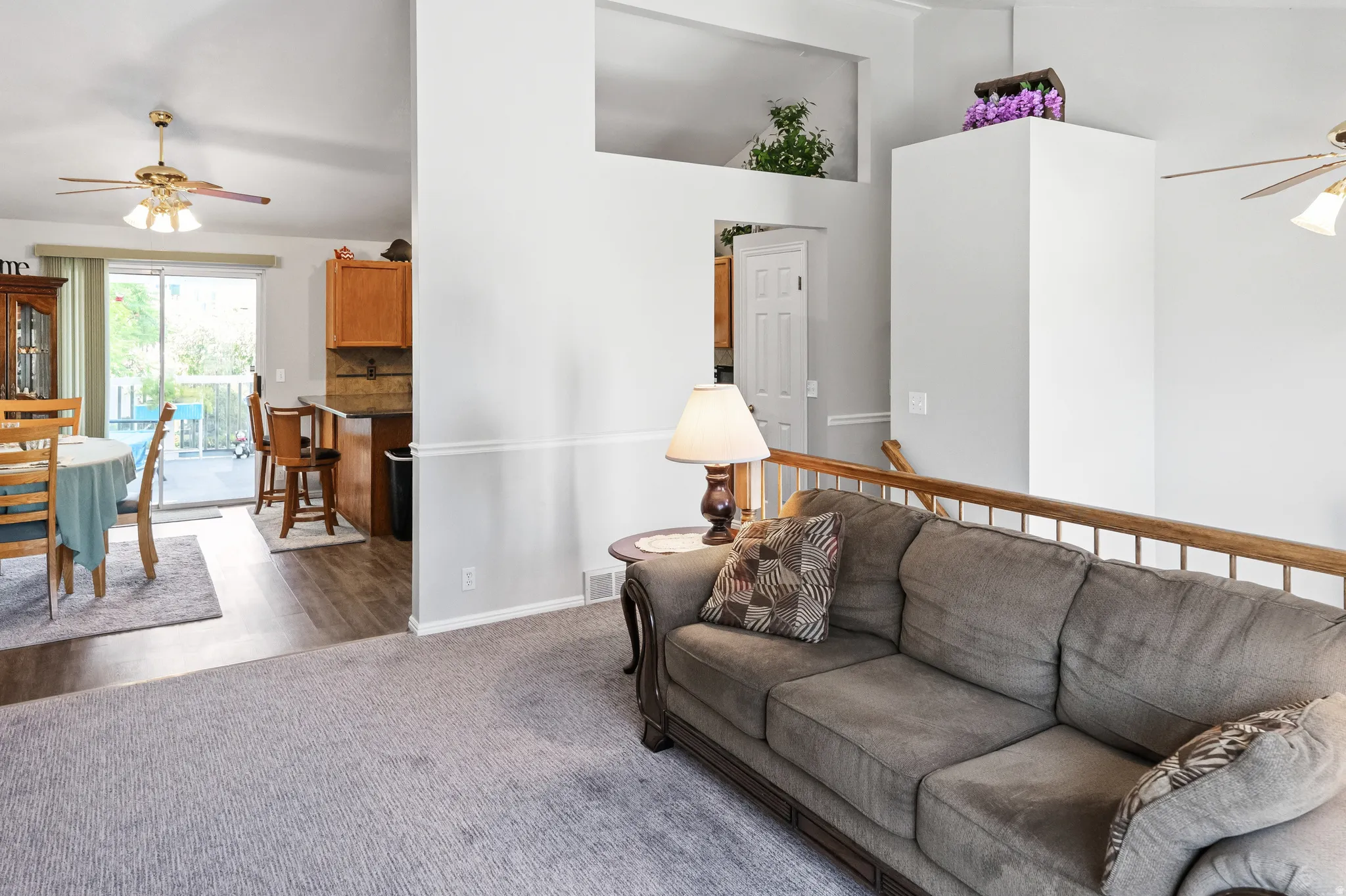 Sunny formal living room with vaulted ceilings and newer carpeting.