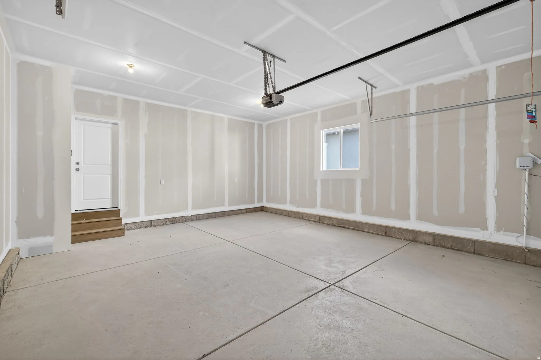 Concrete flooring, overhead lighting, side-entry door, window, automatic garage door opener