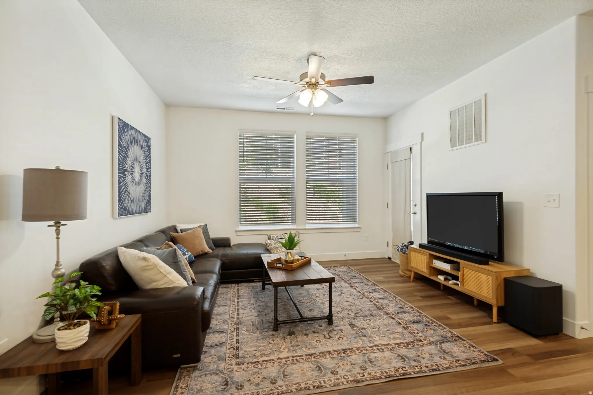 Spacious, light-filled living area with LVP flooring throughout