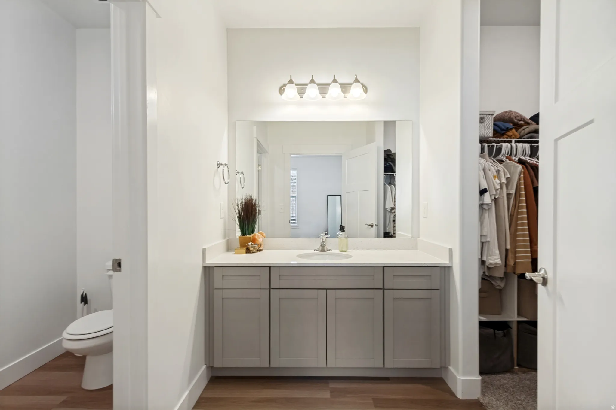 The primary bath boasts a modern vanity with light gray cabinetry, integrated sink, and quartz countertops