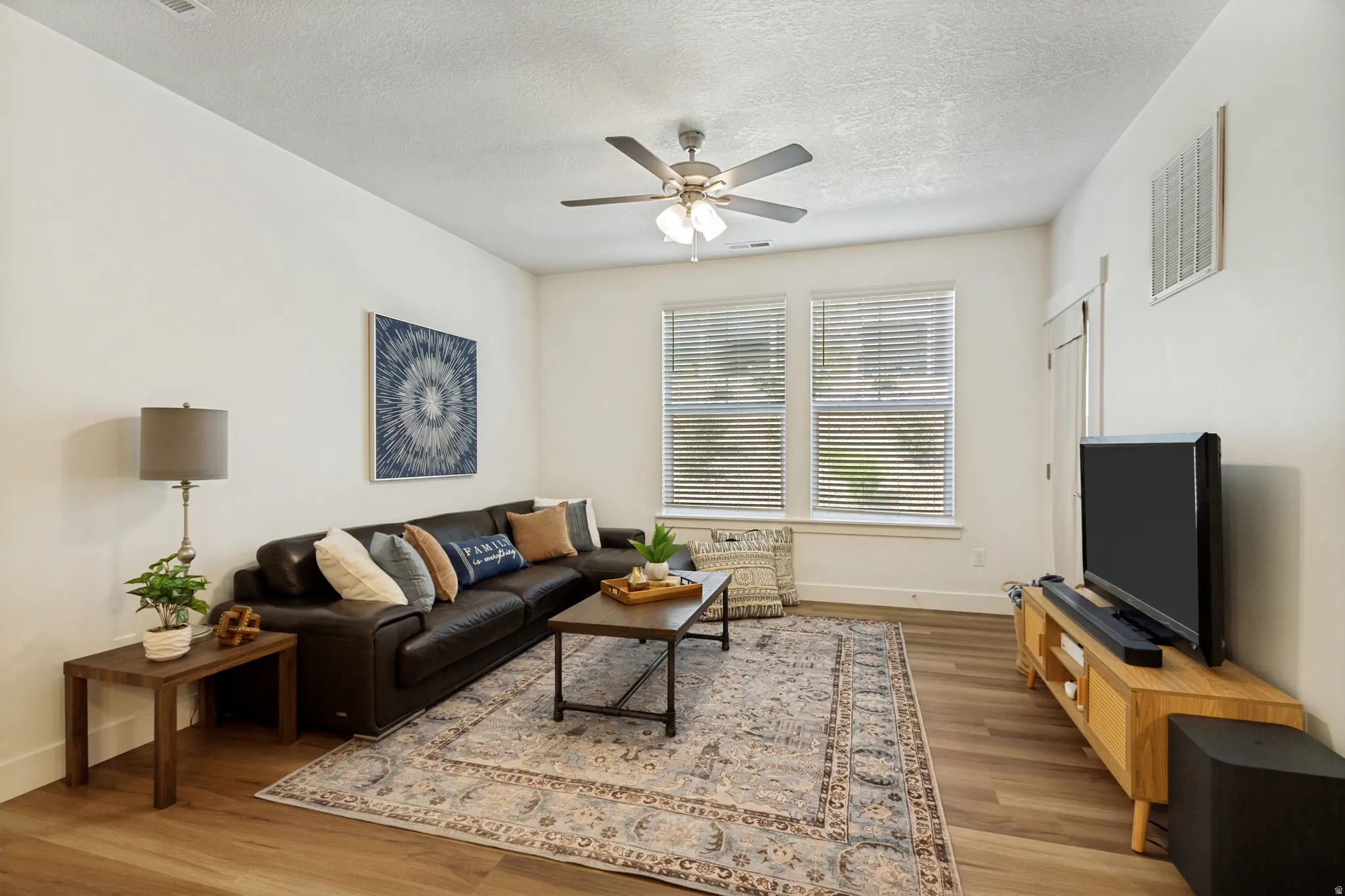 Tall ceilings, large windows and LVP flooring add warmth and welcome to this comfy living space!