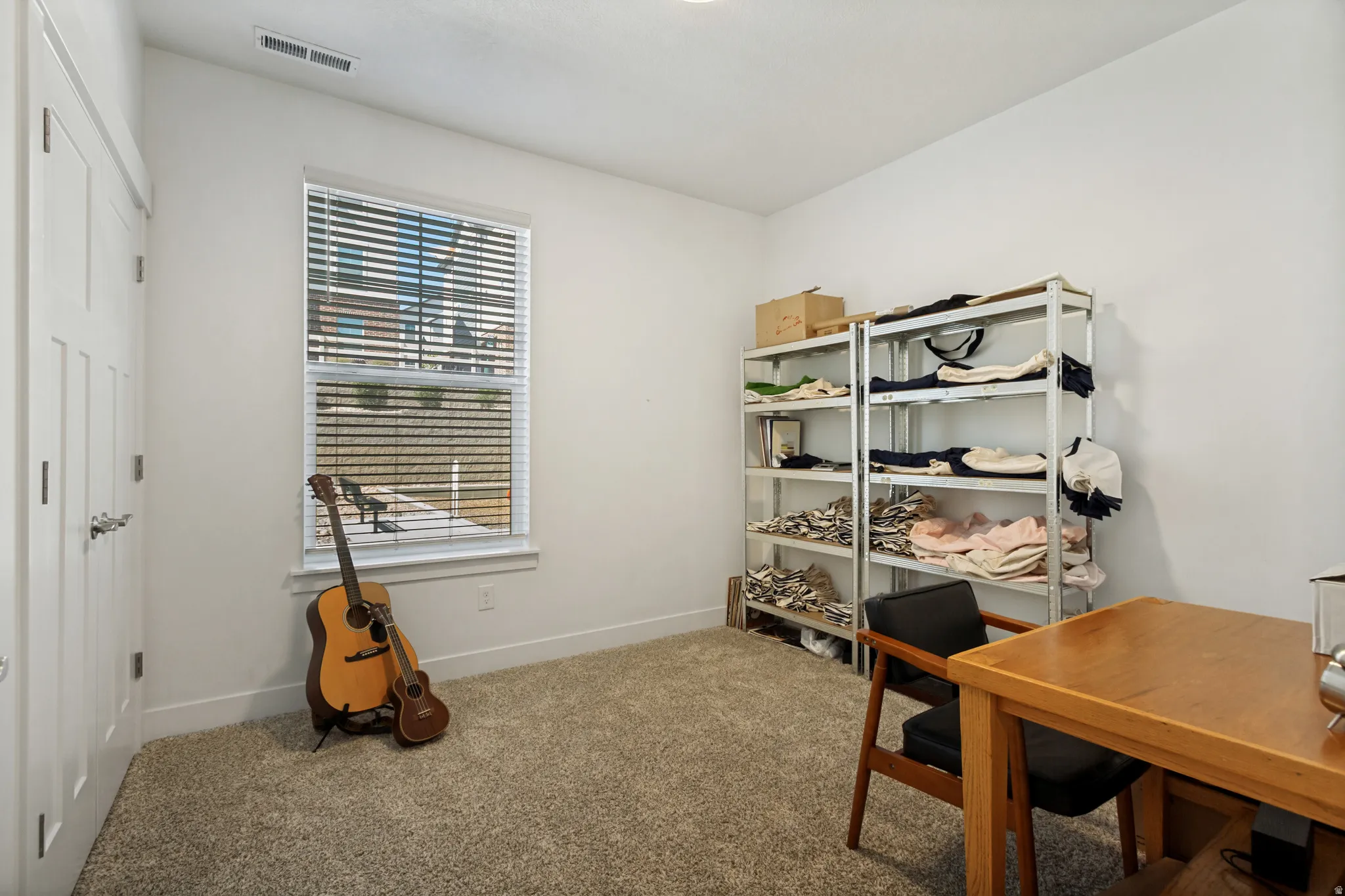 This bedroom is currently functioning as an office, but does include a window and a closet.