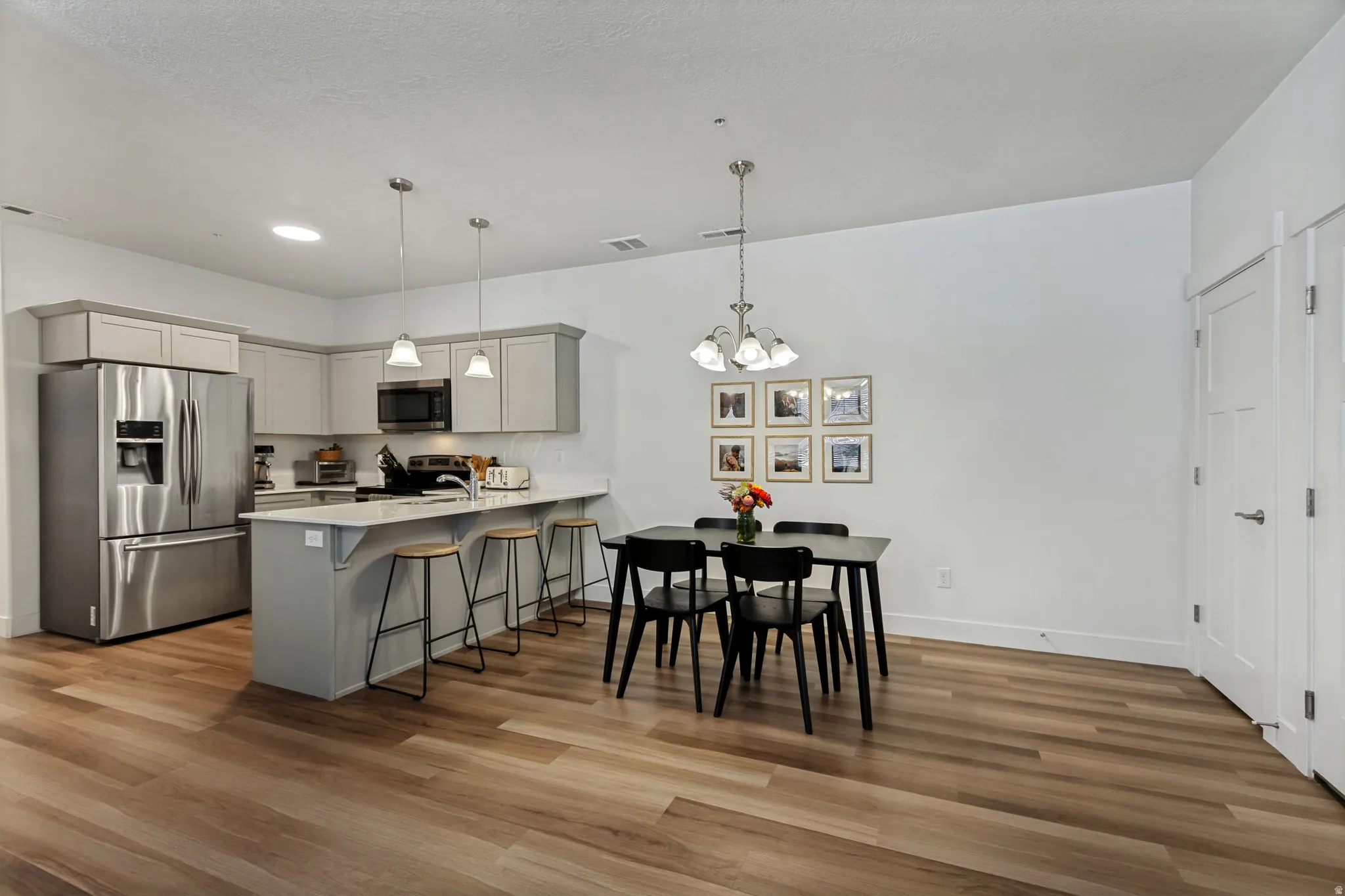 The open-concept living space boasts an ample dining area, kitchen island with quartz countertops and plenty of seating.