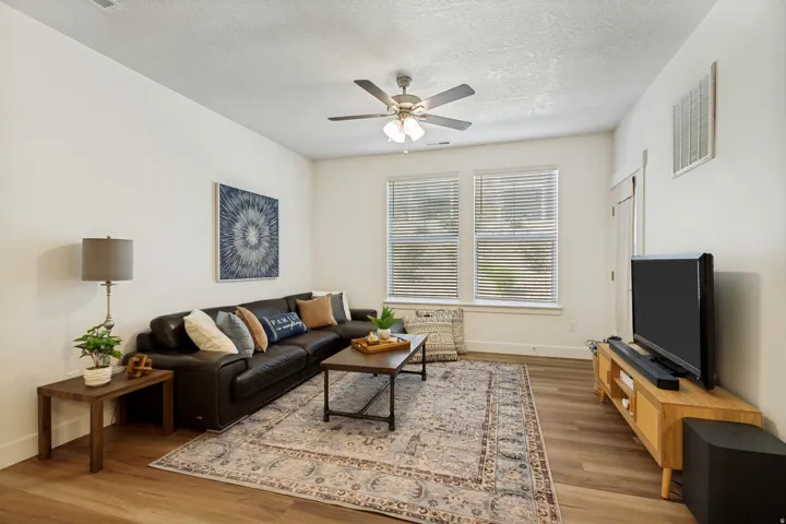 Tall ceilings, large windows and LVP flooring add warmth and welcome to this comfy living space!