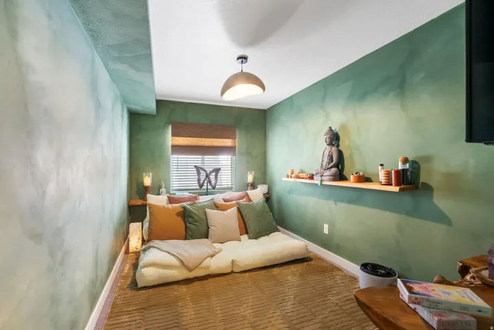 Textured wall finishes, window with blinds, recessed lighting, ceiling-mounted light fixture, wall-mounted shelving