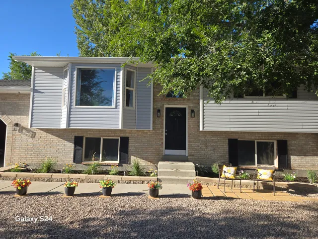 Split-level exterior featuring brick and light gray siding