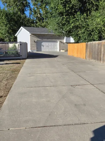 Concrete driveway leading to a detached garage