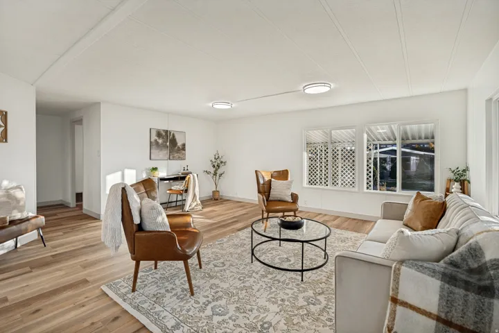 Wood-finish flooring throughout, white walls, and flush mount lighting