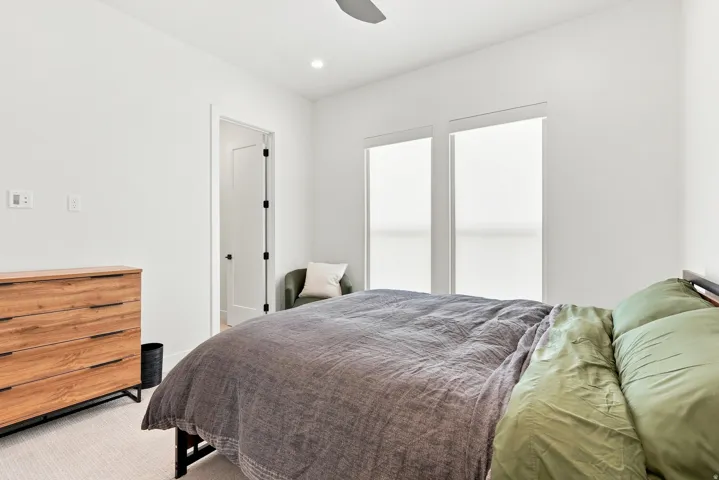 White walls, recessed lighting, and a ceiling fan